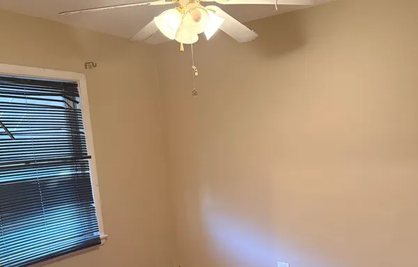 a view of a livingroom with a chandelier fan