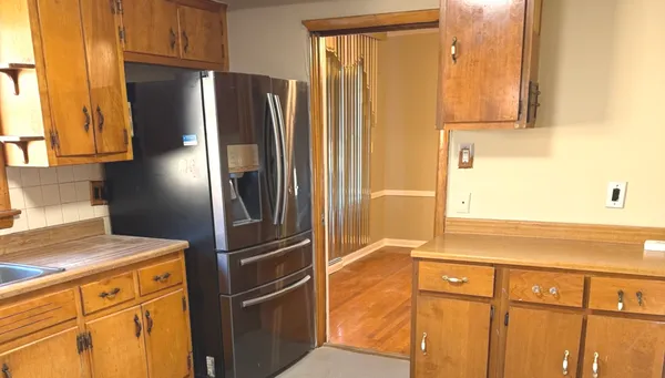 a kitchen with stainless steel appliances granite countertop a refrigerator and a sink