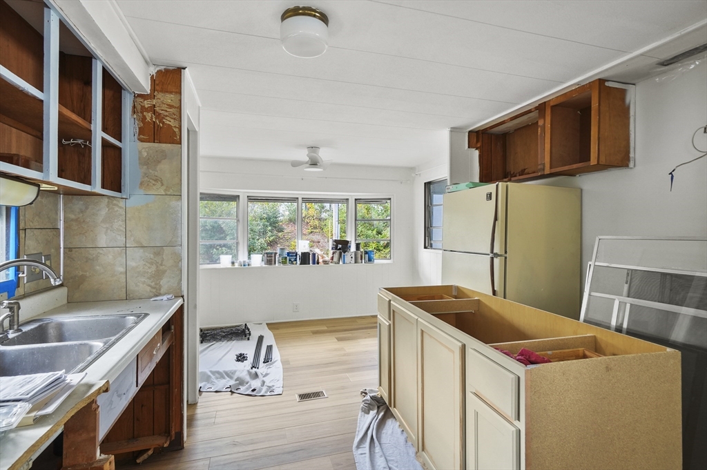 83 Clark Road, Unit 41 Shirley, MA 01464 - Photo 11 of 26 a kitchen that has a sink and a refrigerator