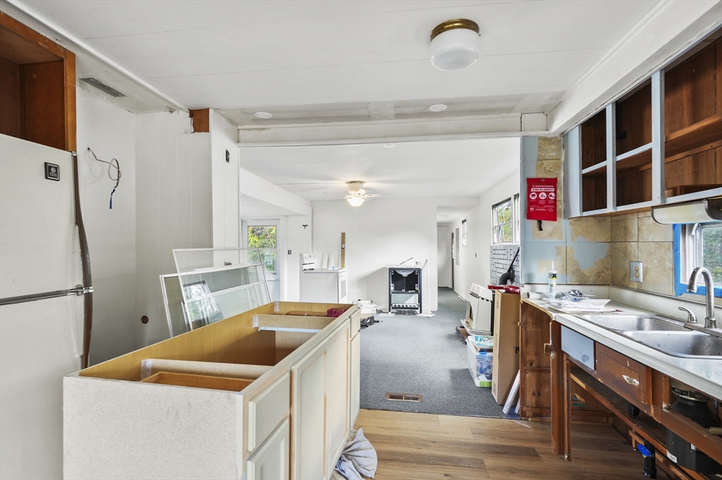 83 Clark Road, Unit 41 Shirley, MA 01464 - Photo 12 of 26 a kitchen that has a lot of cabinets in it and wooden floors