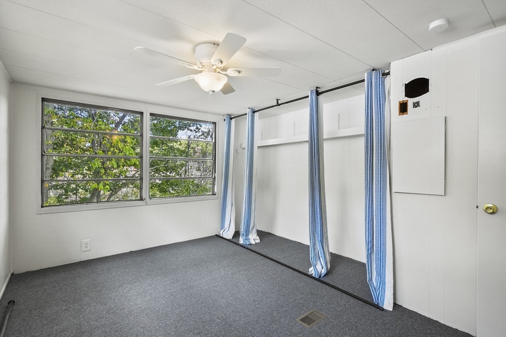 83 Clark Road, Unit 41 Shirley, MA 01464 - Photo 16 of 26 a view of a livingroom with a ceiling fan and window