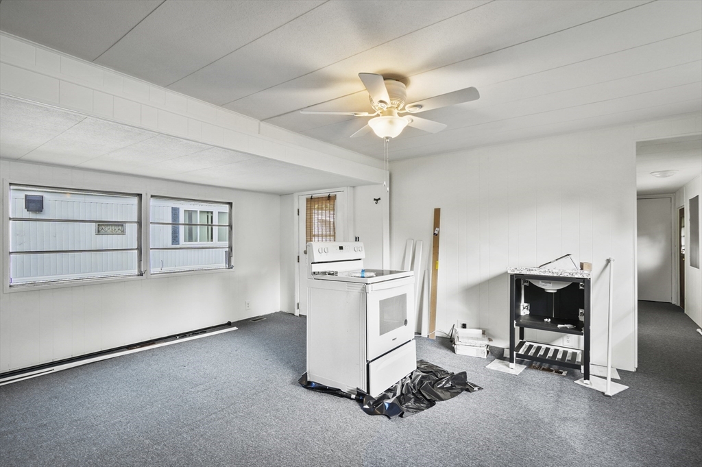 83 Clark Road, Unit 41 Shirley, MA 01464 - Photo 7 of 26 a living room with furniture and a flat screen tv