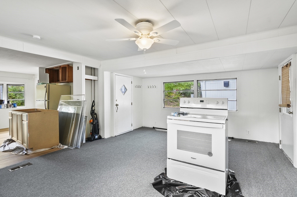 83 Clark Road, Unit 41 Shirley, MA 01464 - Photo 9 of 26 a kitchen with a stove and a refrigerator