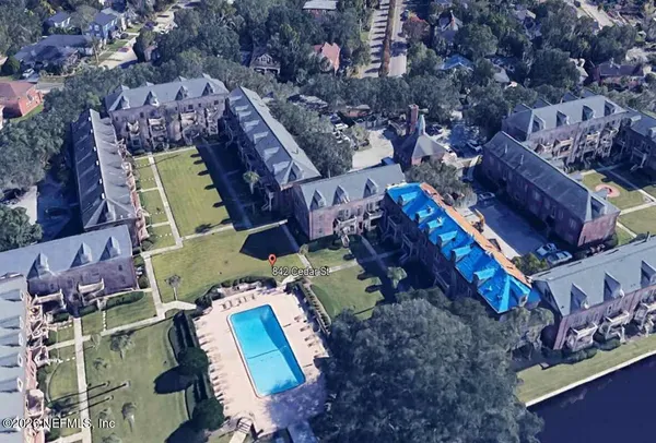 an aerial view of a house with a yard
