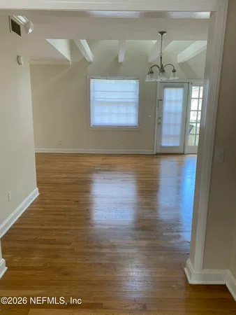 a view of room with wooden floor