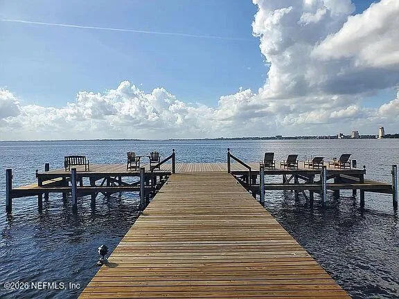 a view of a roof deck with furniture