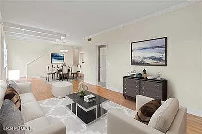 a living room with furniture a rug and a flat screen tv
