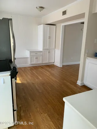 a view of hallway with wooden floor