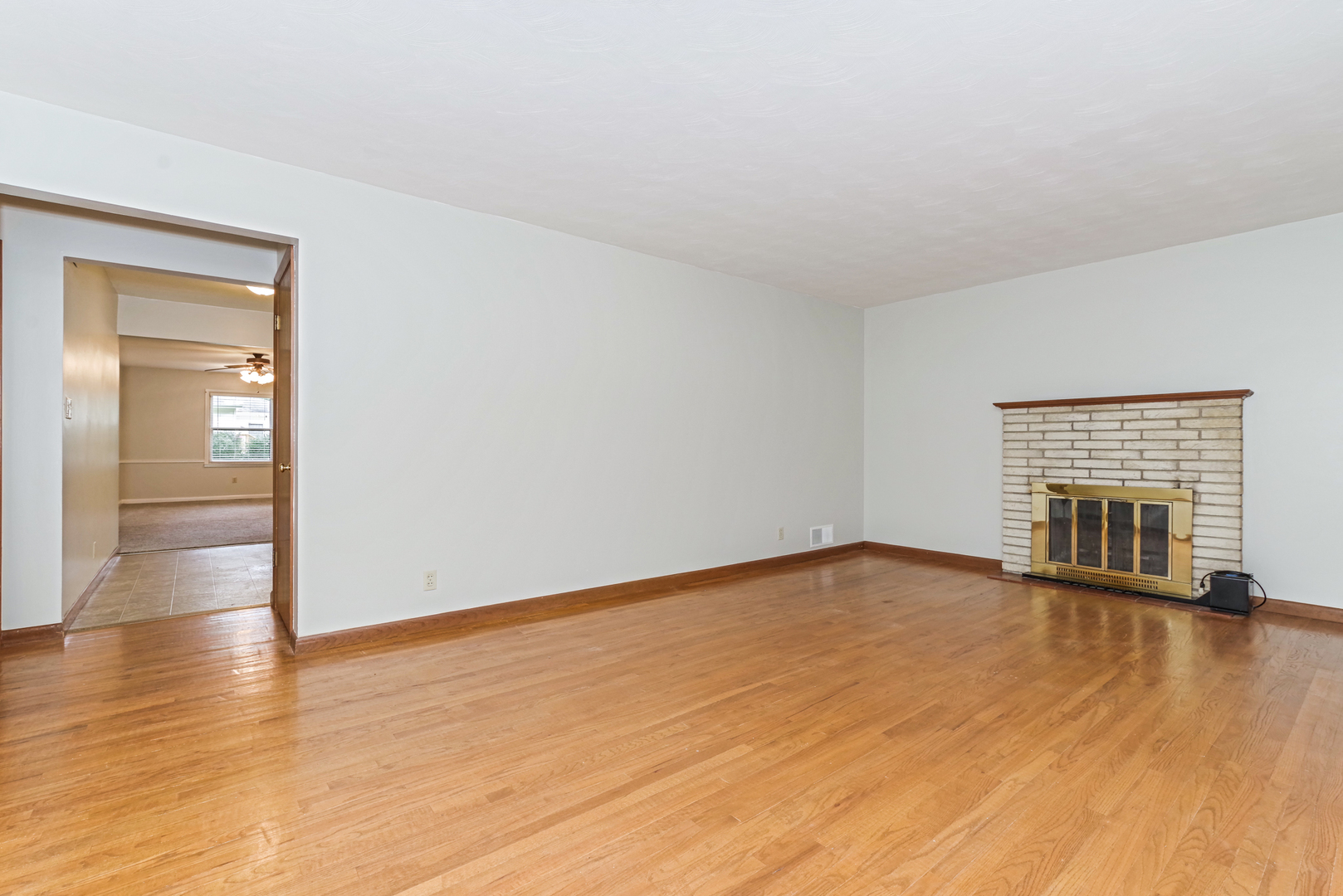 22 Ardith Drive Normal, IL 61761 - Photo 13 of 51 a view of an empty room with wooden floor and a fireplace