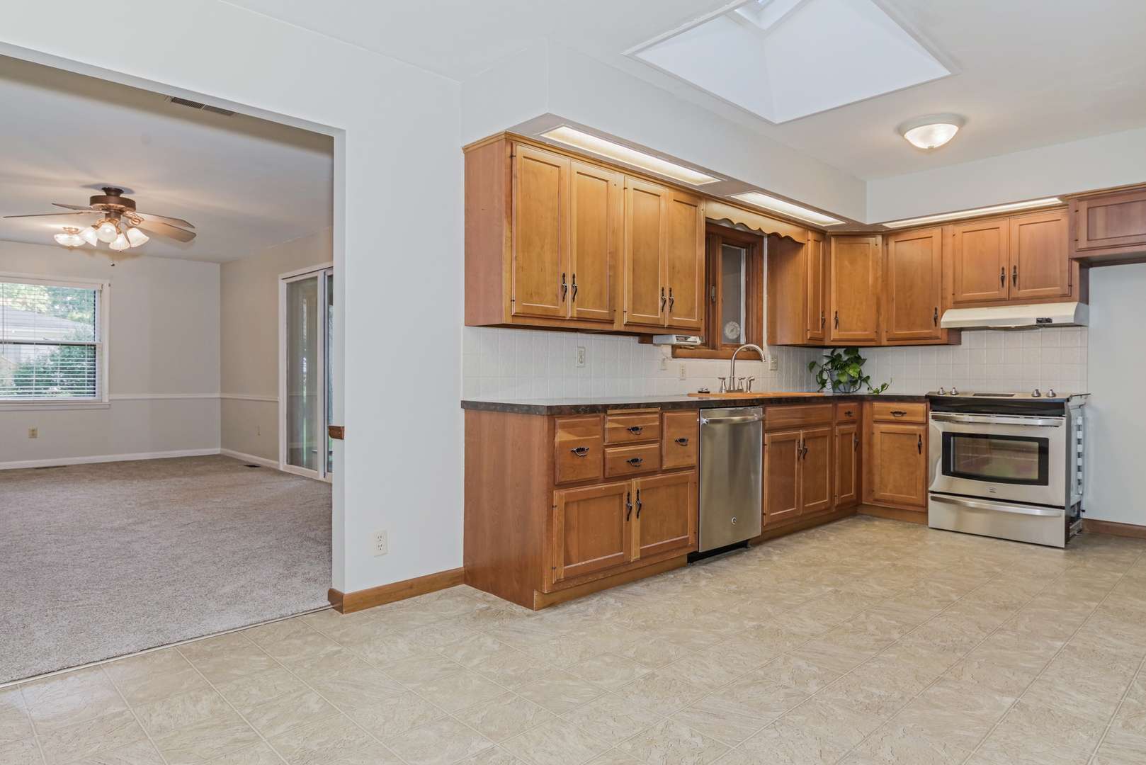 22 Ardith Drive Normal, IL 61761 - Photo 16 of 51 a kitchen with stainless steel appliances granite countertop a stove a sink and a refrigerator