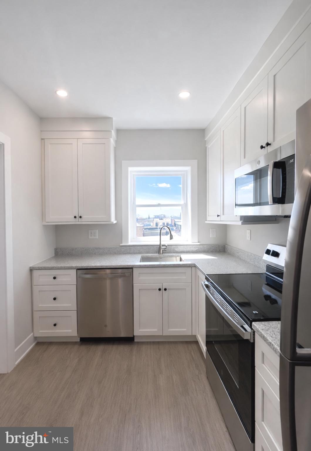 216 West Front Street, Unit 3 Media, PA 19063 - Photo 7 of 17 a kitchen with granite countertop white cabinets and stainless steel appliances