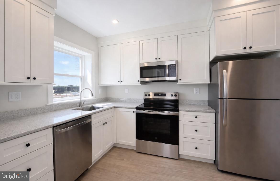 216 West Front Street, Unit 3 Media, PA 19063 - Photo 8 of 17 a kitchen with white cabinets and stainless steel appliances