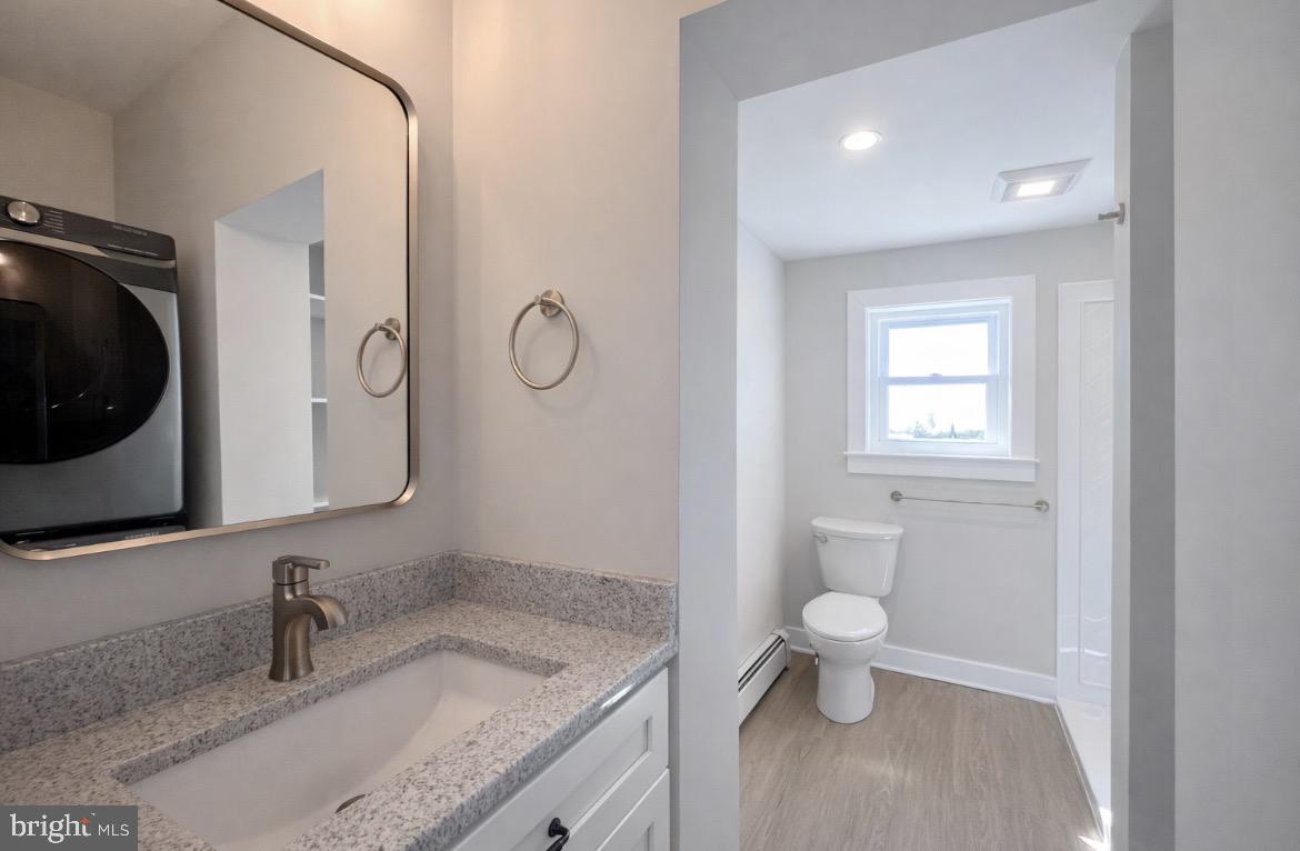 216 West Front Street, Unit 3 Media, PA 19063 - Photo 10 of 17 a bathroom with a granite countertop toilet sink and mirror