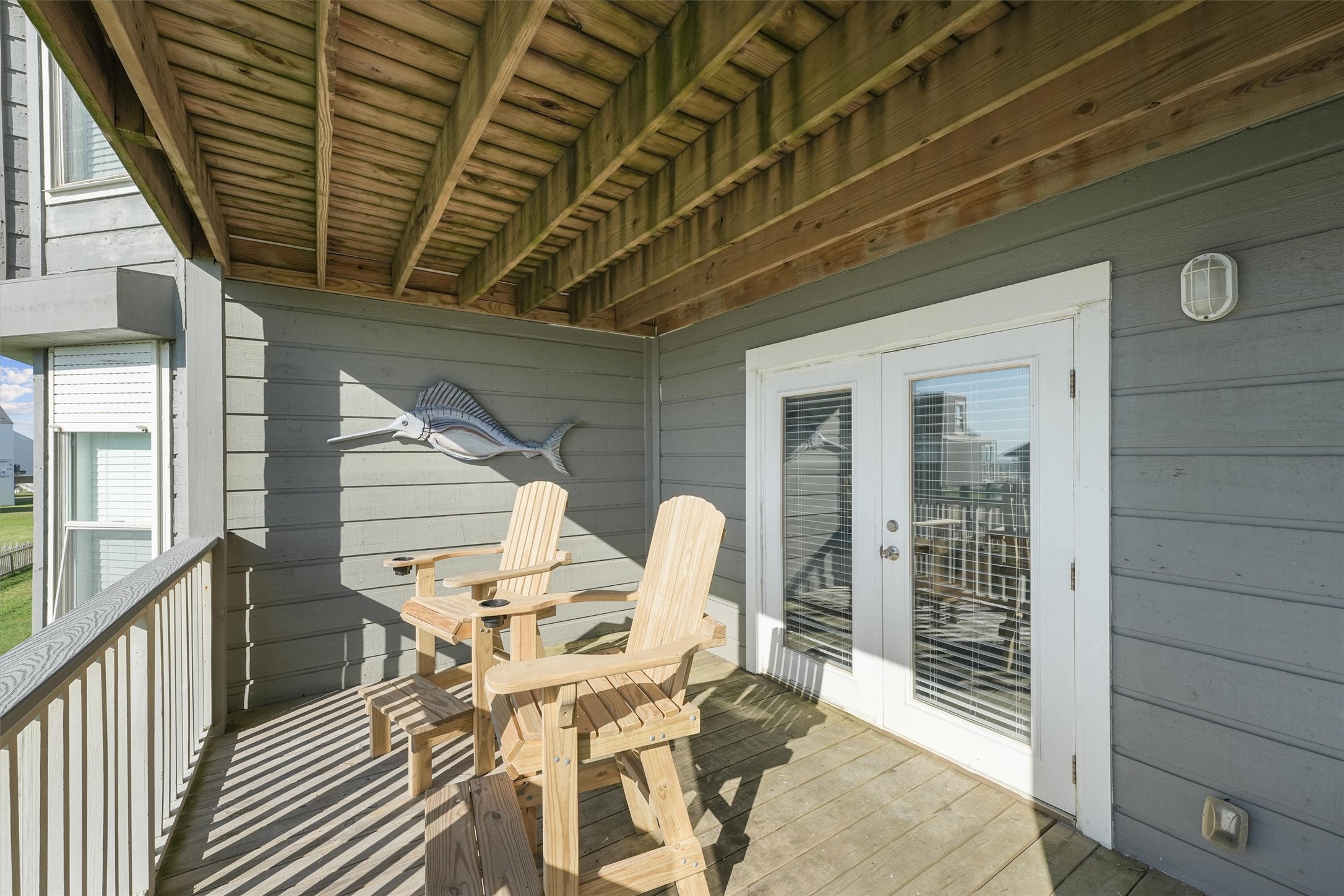 17607 Termini-San Luis Pass Road Galveston, TX 77554 - Photo 25 of 42 The balcony is easily accessed from both bedrooms, providing a seamless indoor-outdoor living experience. Sit back and enjoy the gentle sea breeze in this cozy, shaded setting.