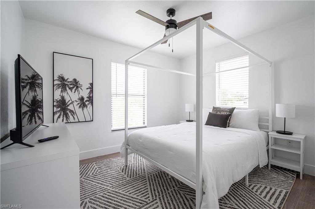 507 14th Street North Naples, FL 34102 - Photo 17 of 33 Bedroom with dark wood-type flooring, multiple windows, and ceiling fan