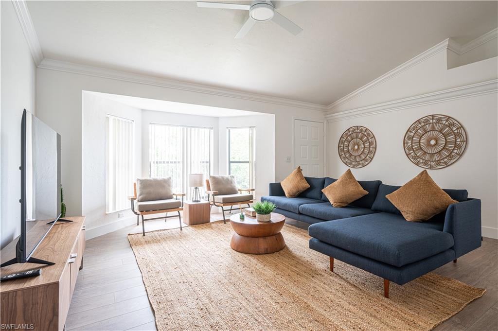 507 14th Street North Naples, FL 34102 - Photo 2 of 33 Living room with ceiling fan, hardwood / wood-style flooring, crown molding, and vaulted ceiling