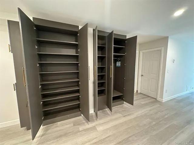 a view of walk in closet with empty racks