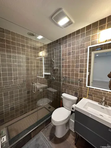 a bathroom with a sink mirror toilet and shower