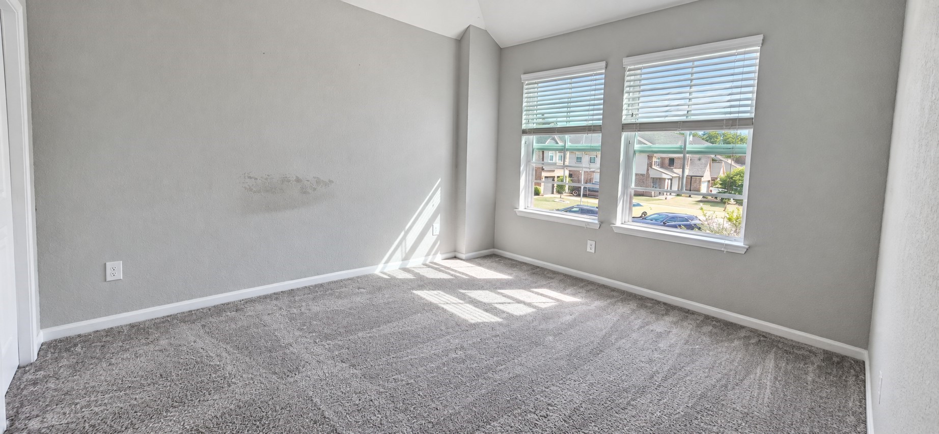 11355 Cascading Stream Way Houston, TX 77044 - Photo 12 of 17 Bright and inviting bedroom with soft carpeting, neutral tones, and large windows offering plenty of natural light and views of the neighborhood.