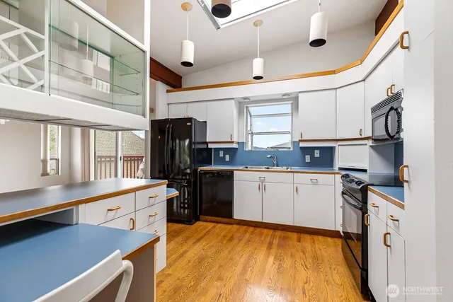 a kitchen with stainless steel appliances granite countertop a sink and cabinets