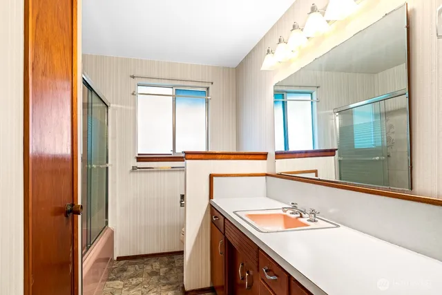 a bathroom with a sink and a mirror