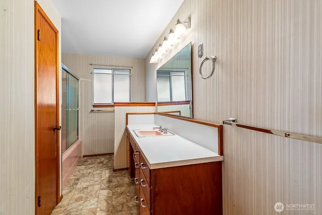 a bathroom with a sink vanity and a mirror
