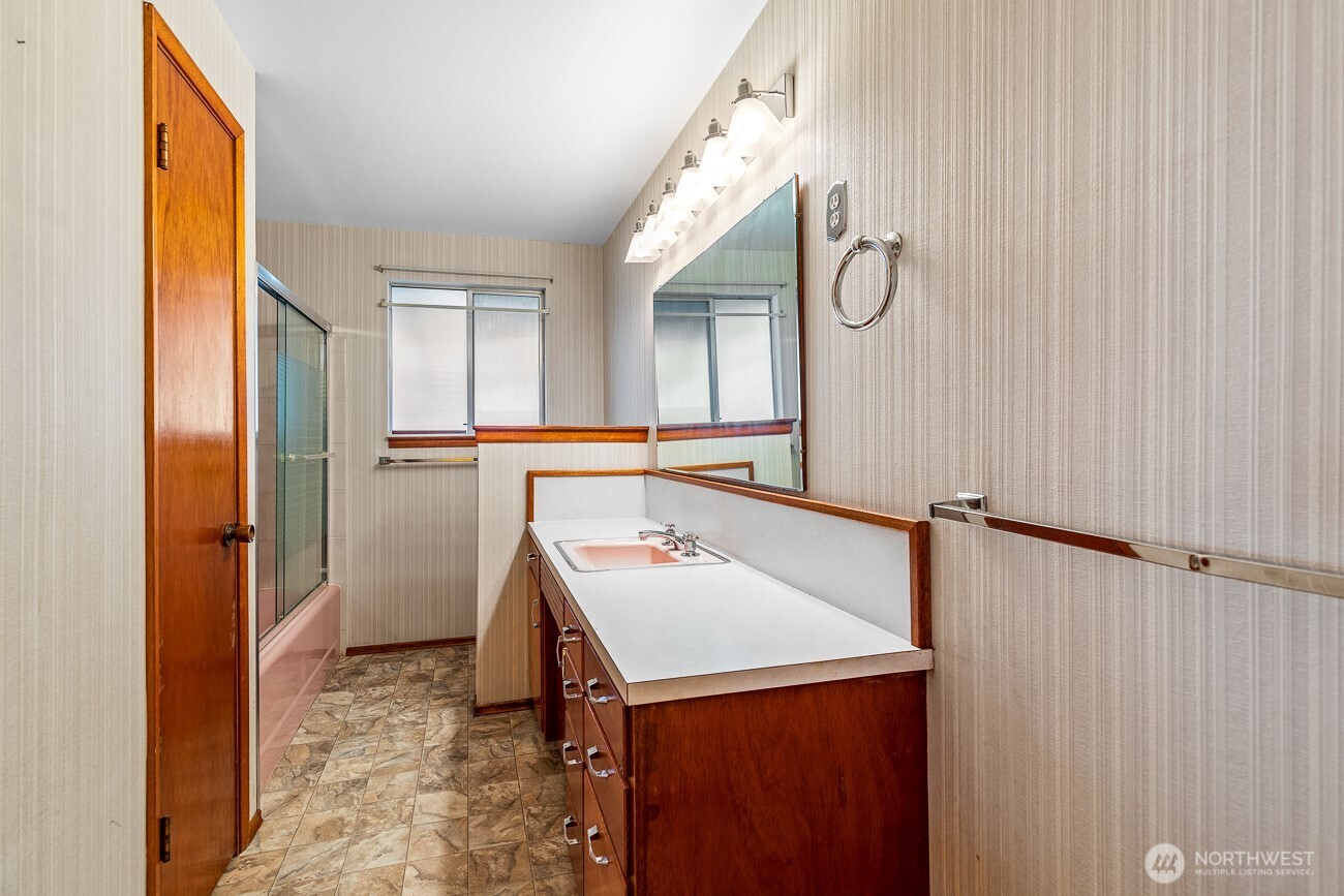 1006 North 36th Street Renton, WA 98056 - Photo 14 of 21 a bathroom with a sink vanity and a mirror