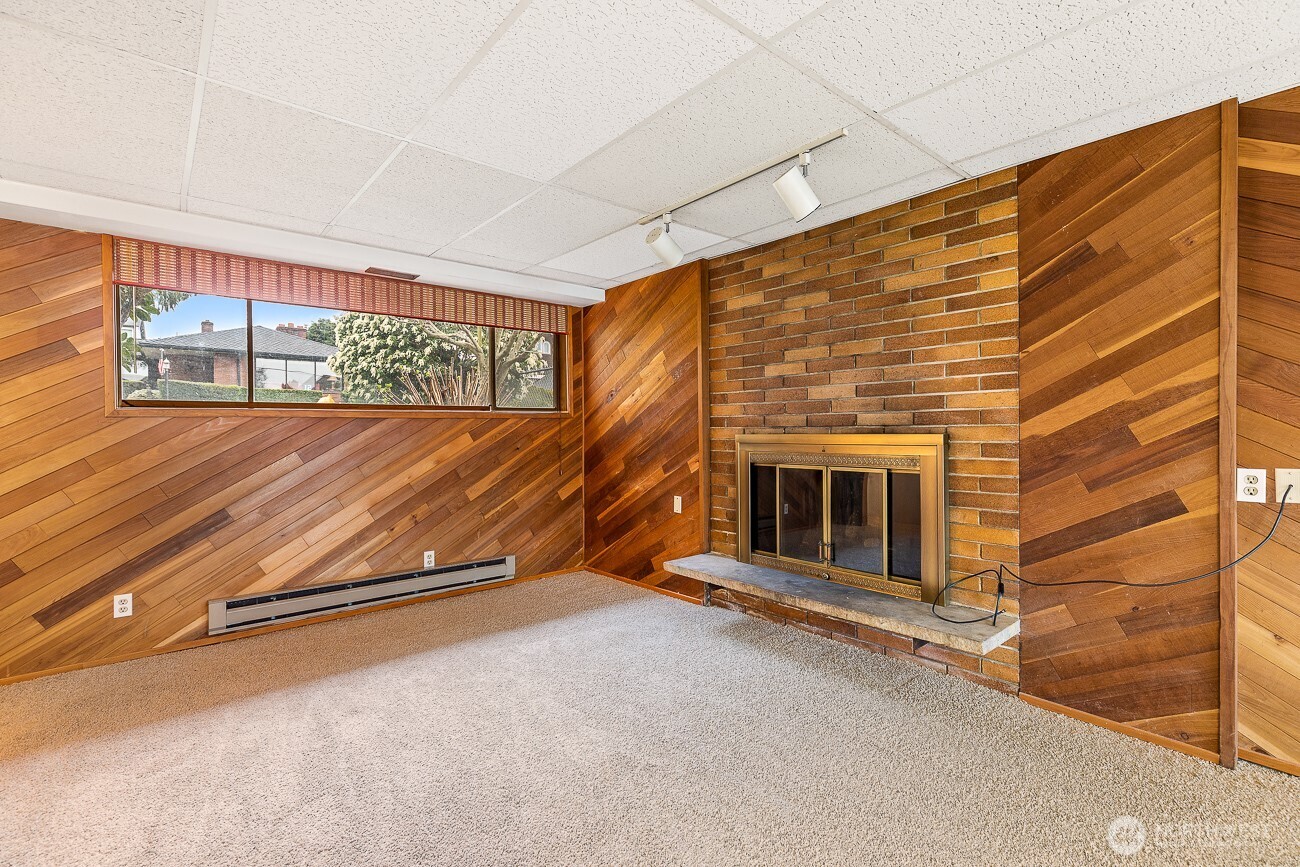 1006 North 36th Street Renton, WA 98056 - Photo 16 of 21 a view of an empty room with wooden floor and a window