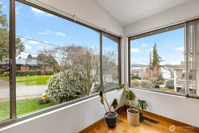 a view of a room with a large window and bed