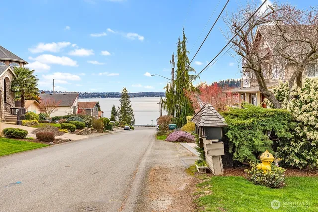 a view of a chair and table in backyard of the house