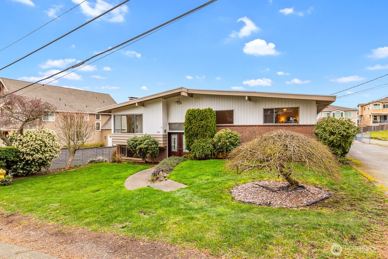1006 North 36th Street Renton, WA 98056 - Photo 3 of 21 a view of a house with a backyard and porch
