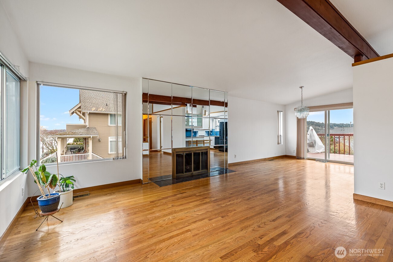 1006 North 36th Street Renton, WA 98056 - Photo 4 of 21 a living room with stainless steel appliances wooden floor and a large window