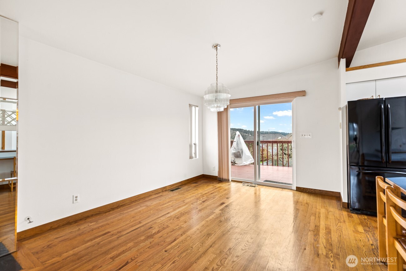 1006 North 36th Street Renton, WA 98056 - Photo 5 of 21 a view of empty room with wooden floor and fan