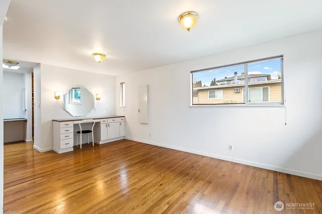 a view of a room with wooden floor and window