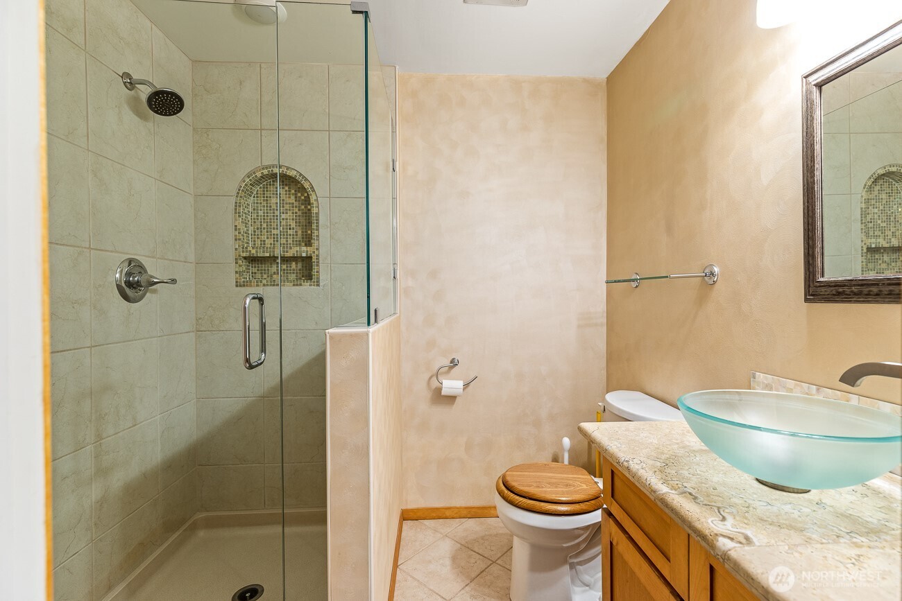 1006 North 36th Street Renton, WA 98056 - Photo 9 of 21 a bathroom with a granite countertop sink toilet and shower