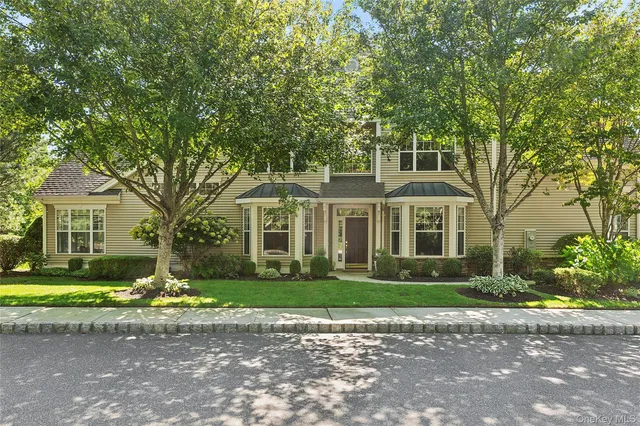 a front view of a house with a garden