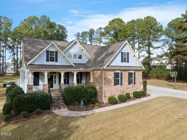 a living room with furniture ceiling fan and a fireplace
