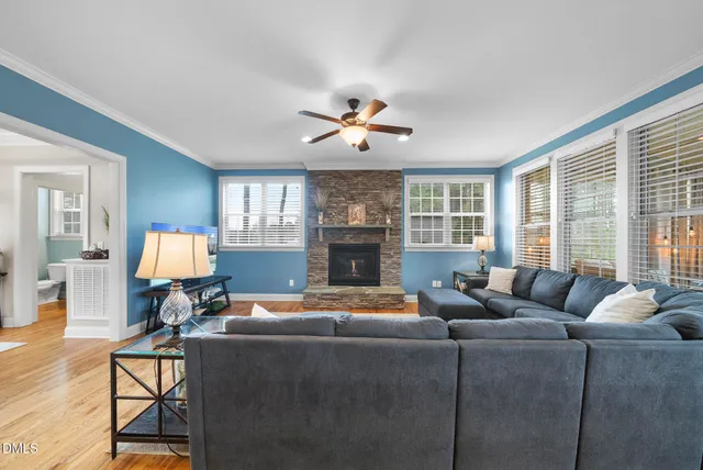 a dining room with furniture a chandelier and wooden floor
