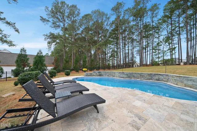 a view of a swimming pool with lounge chairs
