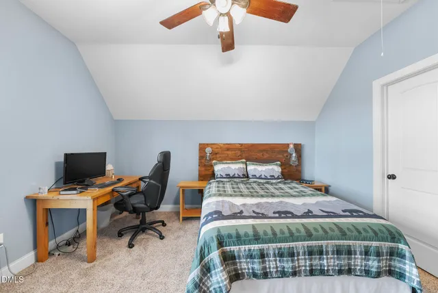 a view of swimming pool with seating space and trees in the background