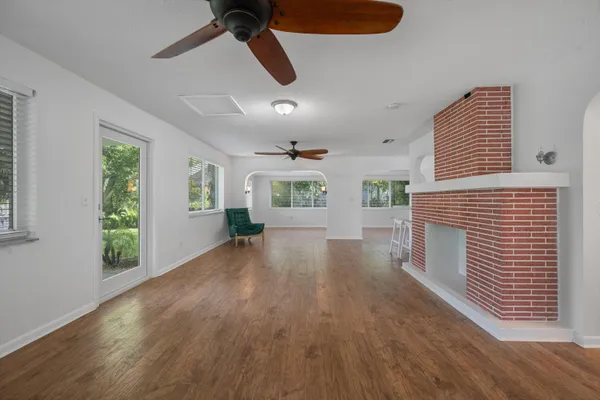 a view of a livingroom with wooden floor and a ceiling fan