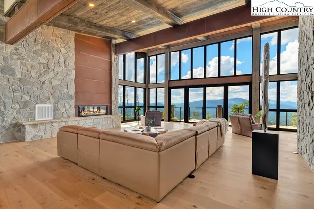 a living room with furniture and large windows