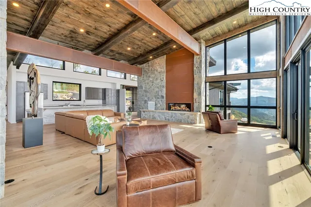 a living room with furniture and a floor to ceiling window