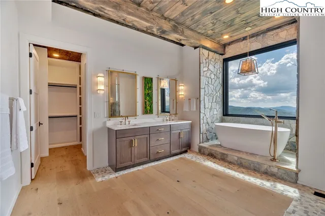 a large bathroom with a large mirror vanity and bathtub