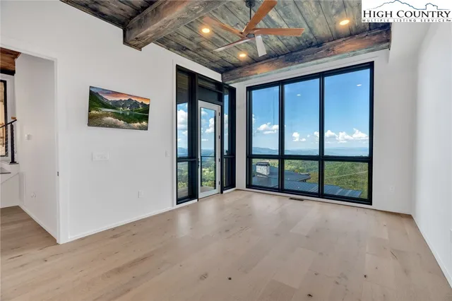 a view of a room with wooden floor
