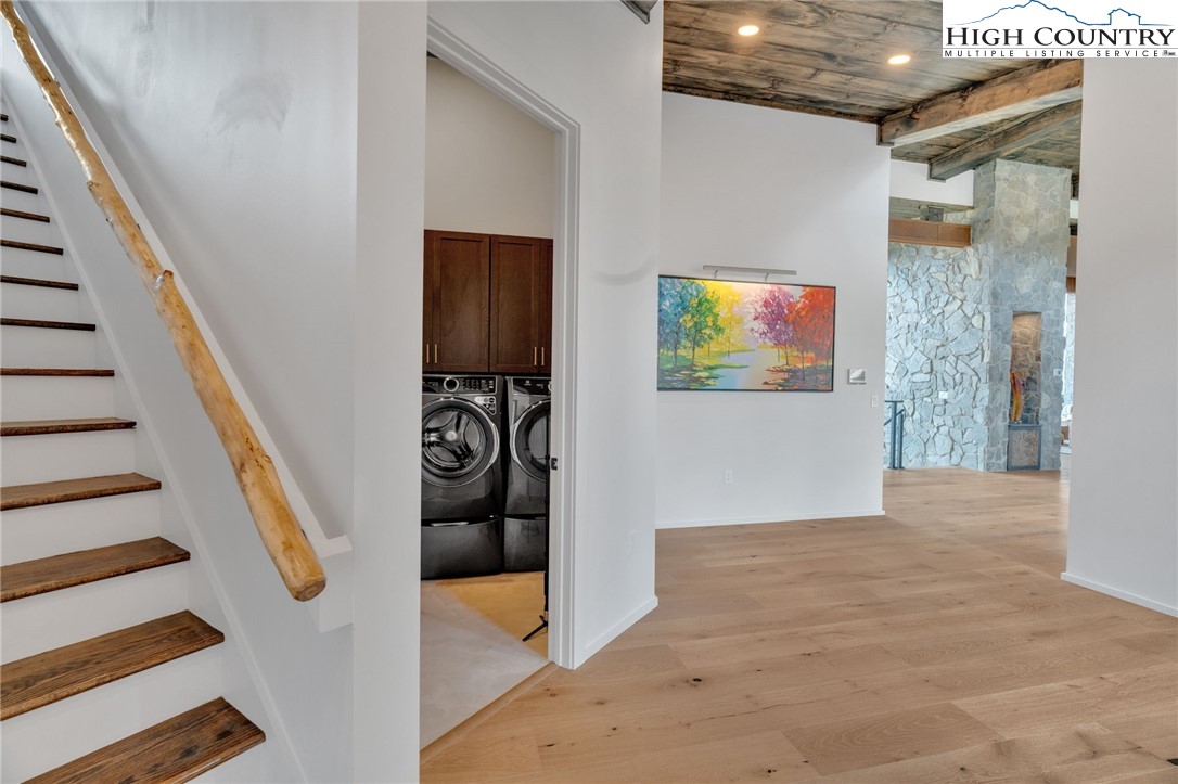294 Silver Eagle Trail Banner Elk, NC 28604 - Photo 39 of 50 a view of a hallway with wooden floor and staircase