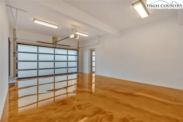 an empty room with windows and entrance