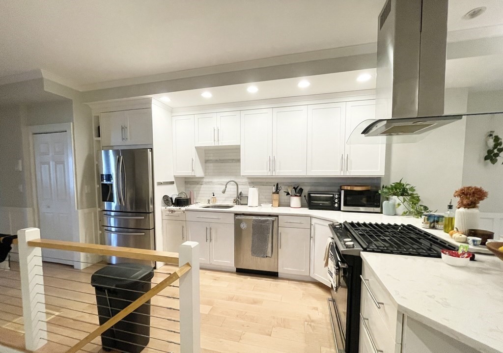 108 Buttonwood Street, Unit 1 Boston, MA 02125 - Photo 2 of 12 a kitchen with a stove a sink and a refrigerator