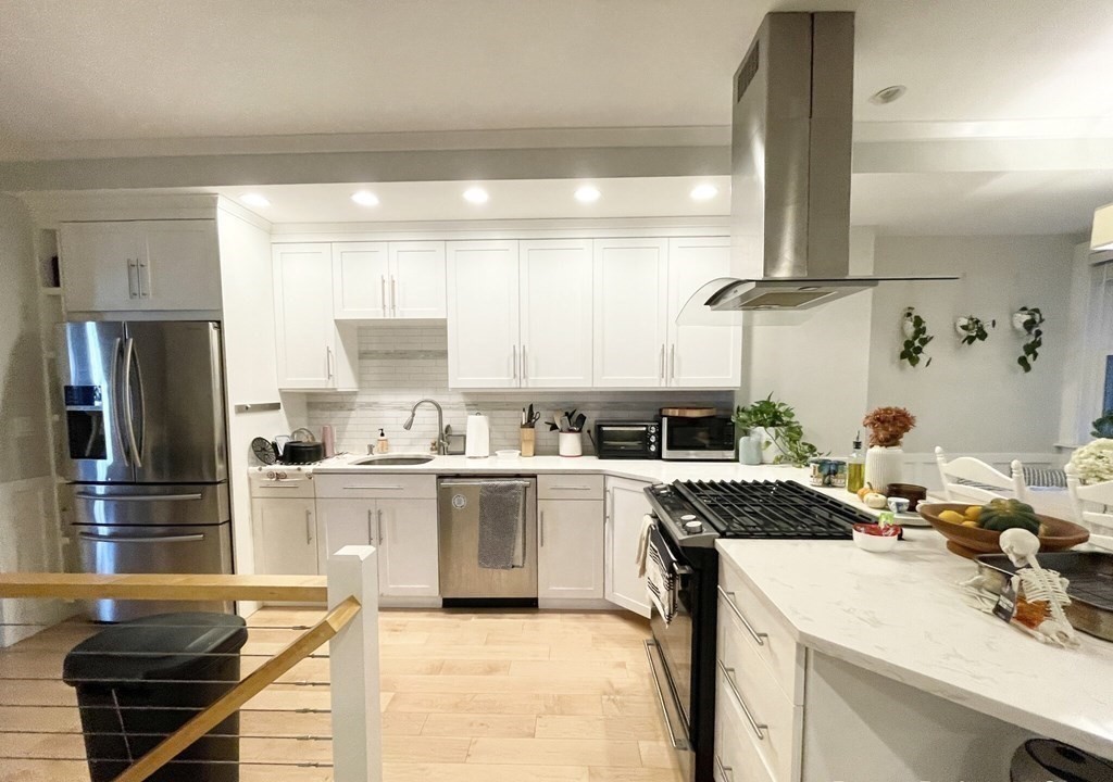 108 Buttonwood Street, Unit 1 Boston, MA 02125 - Photo 3 of 12 a kitchen with a sink stove and refrigerator