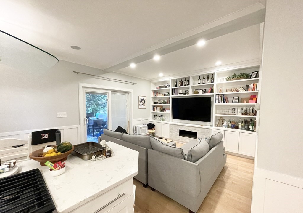 108 Buttonwood Street, Unit 1 Boston, MA 02125 - Photo 5 of 12 a living room with furniture and a flat screen tv